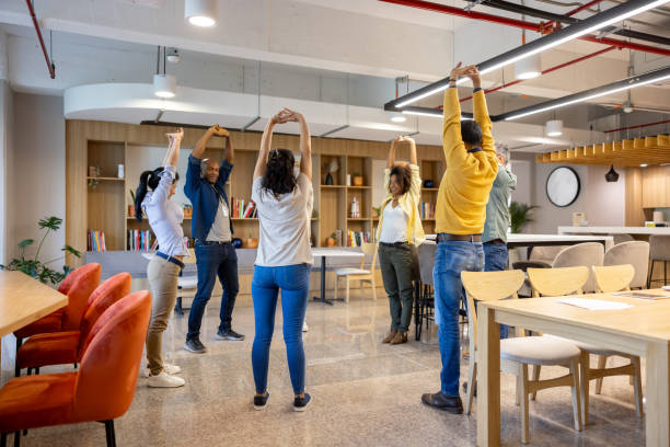 Group of Latin American business people taking an active break at the office and stretching