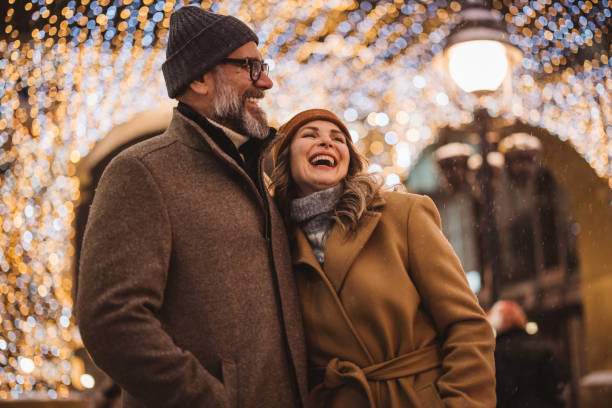 Mature couple in the city walking and having fun on winter day.